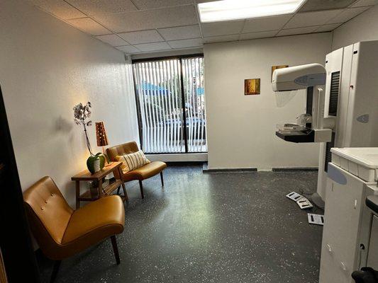 Picture of mammography room with the mammography machine and chairs