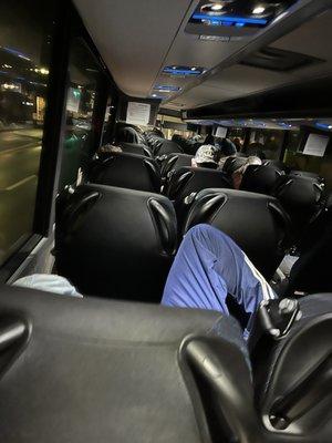 The woman on the bus right side was starting to complain about this guys position. People who sit like this have no class....