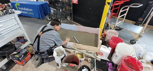 Raymond demonstrating on how to build a shower pan.