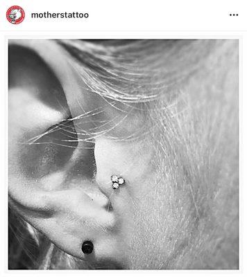 tragus piercing by Rene