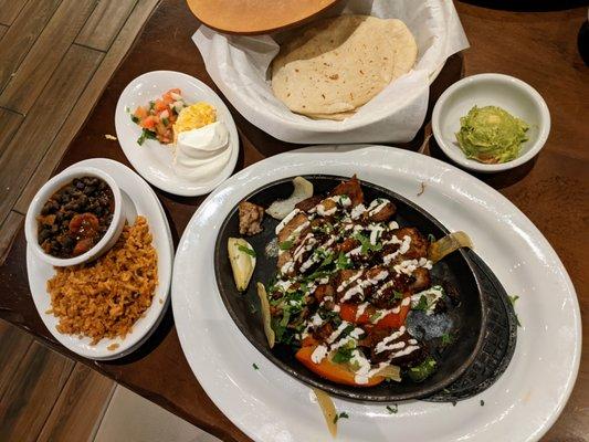 Carnitas Fajitas. $22. Savory braised pork with honey chipotle glaze, crema and fresh cilantro. Fresh guac, pico, sour cream, cheese, etc.