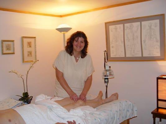 Laura doing acupuncture with a client.