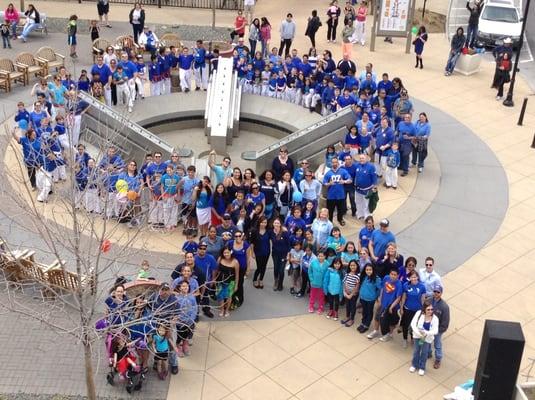 CASA supporters make a blue ribbon during Child Abuse Prevention Month