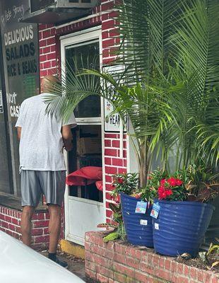 The takeout window is the bottom half of a screen door.