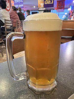 Large beer with a full head of foam.