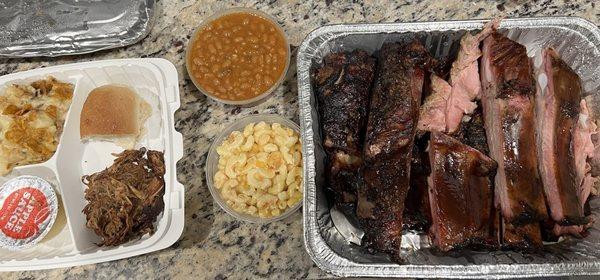 Full rack of bbq ribs, Mac and cheese, hickory beans, cheesy potatoes, pulled pork slider, apple sauce