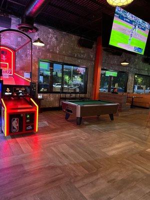 More games inside the bar area. Billiards, basketball and golf simulator.