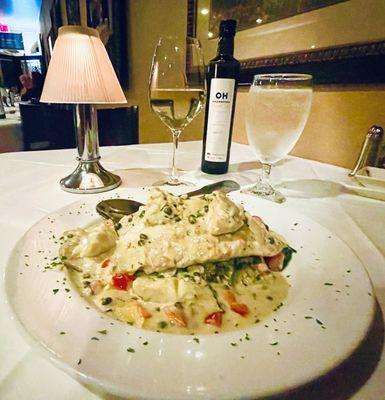 This evenings special. Barramundi with a caper artichoke sauce layered over aioli capellini and sautéed spinach. Heavenly!