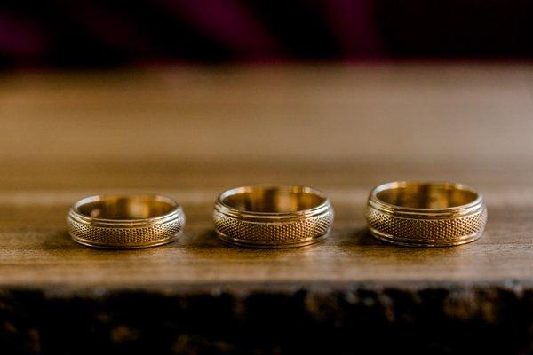 The DG Aggie Wedding Band mirrors the rugged accents of the base of the well-famed Aggie Ring.