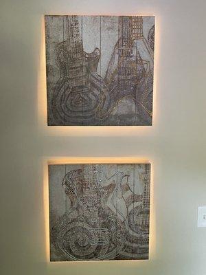 Property Butler executed accent lighting behind two Gibson Guitar pieces of art.