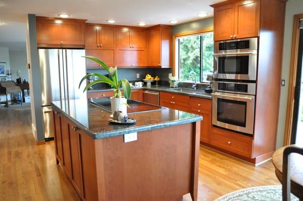 Transitional cherry kitchen with a tapered leg island, granite counters.