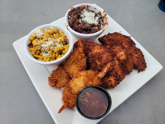 Coconut chicken and shrimp combo with flame-roasted corn and black beans.