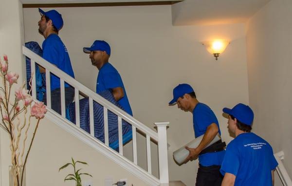 UniRelo Moving crew walking upstairs to pack the bed rooms