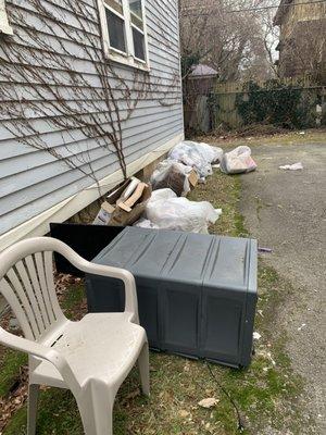 Garbage left of the side of  my building for weeks.