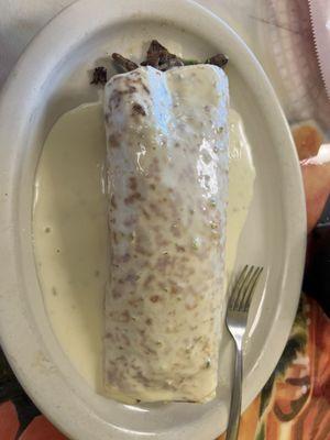 Burrito Asada - Fajita style cut meat - Drained in cheese sauce .