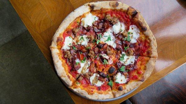 Sausage Party Pizza with bacon, sausage, salami, coppa, tomato and saba.