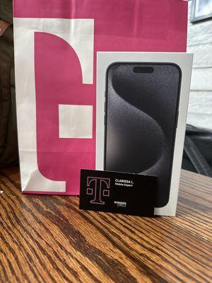 T-Mobie rep card, iPhone 15 and T-Mobile bag.