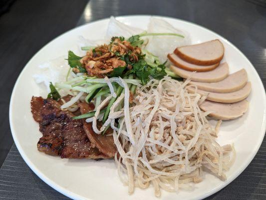 15. Banh Uot Bi Cha Thit Nuong Classic rice crepe with shredded pork, seasoned BBQ pork, Vietnamese ham. shrimp & sweet potato fritter, herb