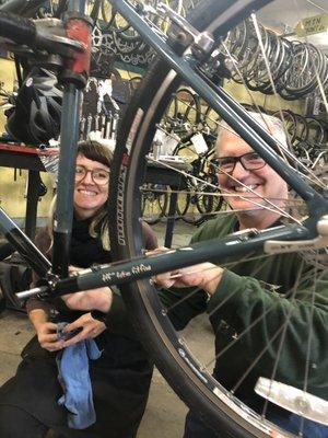 Bike Church Master Mechanic helps a customer with a bike repair.