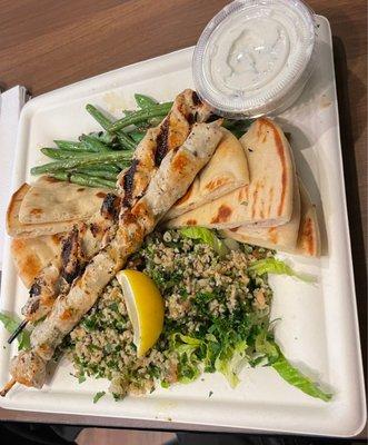 Chicken skewer plate with green beans, tabouleh salad and tzatziki. It came with pita.