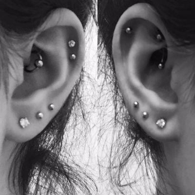 The left daith and the right rook and single helix done by Tami.