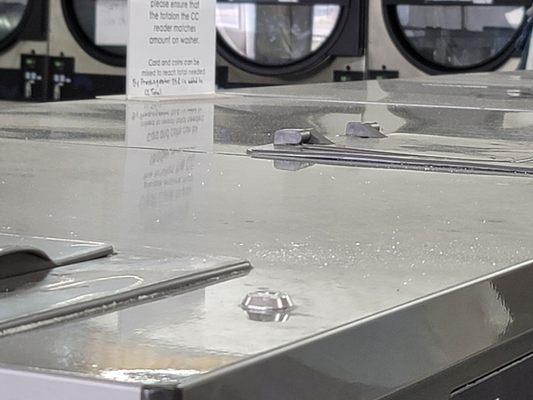 Tops of washing machines- lots of liquid and powder soap collecting