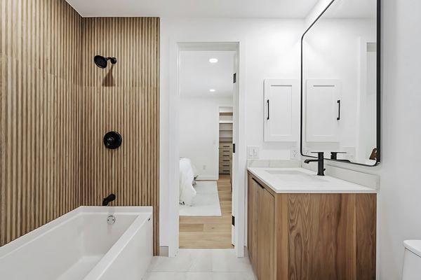 This breathtaking bathroom renovation showcases our Hudson vanities paired with Soho Mirrors.