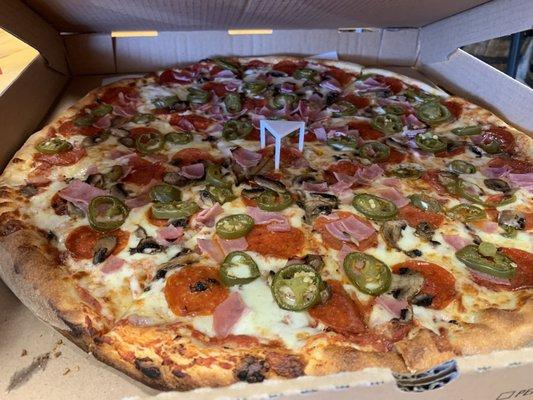 Pizza with pepperoni, ham, and jalapeno