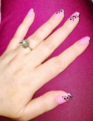 SNS on natural nails with leopard print design on edges of some fingers.