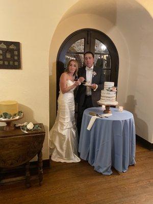 Flowers on the main cake and eucalyptus on grooms cake