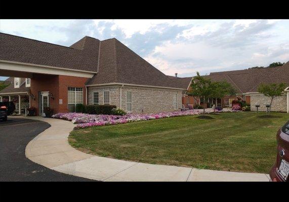 Front of the building, with a beautiful landscape full of flowers!