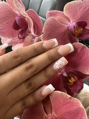 Ivy creates a perfect flower on French tips - Builder Gel on clients natural nails.