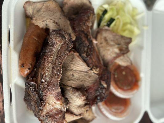 BBQ beef rib, pork rib, tri tip, sausage and chicken quarter with salad.