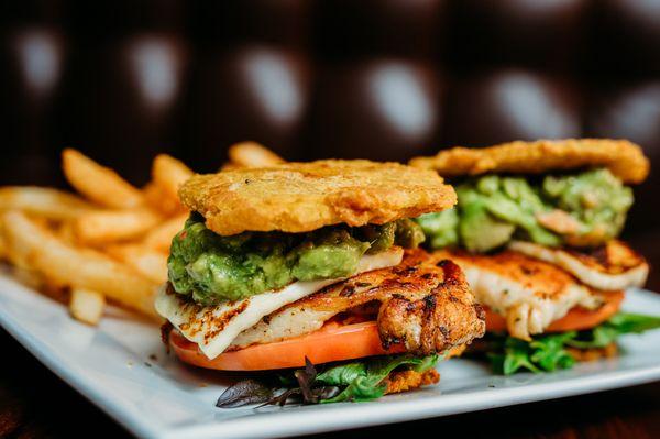 Grilled Chicken Sandwich on tostones with guacamole