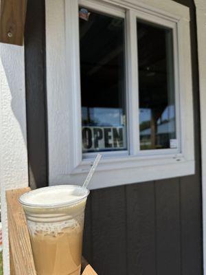 A delicious vanilla latte with oatmilk and vanilla cold foam.