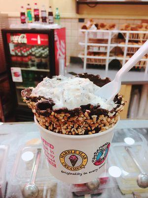 Cheesecake ice cream with nuts in a waffle cone