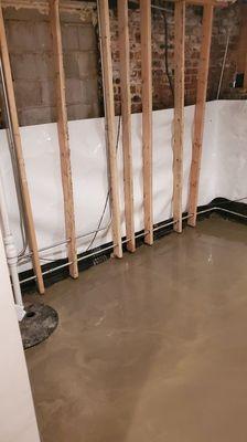 Complete concrete slab with draintile and aqua curtain installation