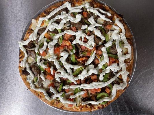 The Gyro Pizza( topped with Gyro meat, green peppers, onions, tomatoes, and tzatziki sauce)