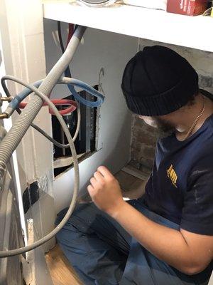 Harvey solving our leak, hidden behind the washing machine.