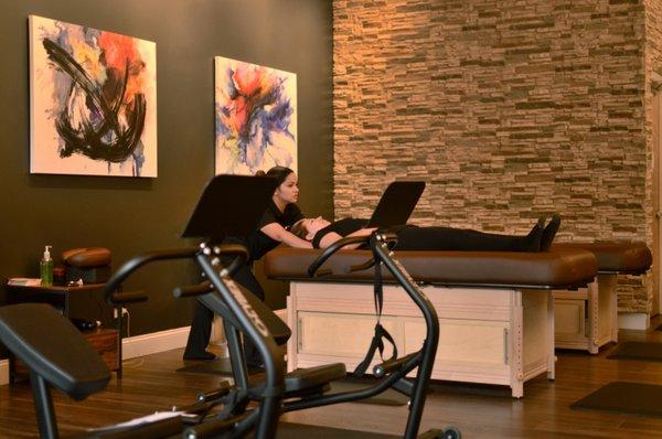 A calm, modern space with warm lighting and soothing art--our studio offers a tranquil vibe for personalized stretch therapy sessions.