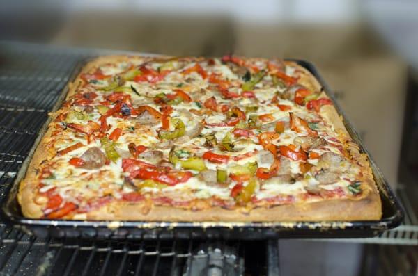 Sicilian Pizza with roasted red and green peppers and sliced Italian sausage.  Simply delicious!!