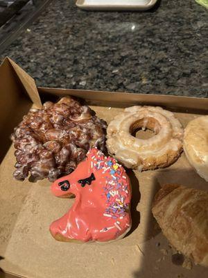 Unicorn sprinkle donut, apple fritter, sour cream donut, croissant kolache