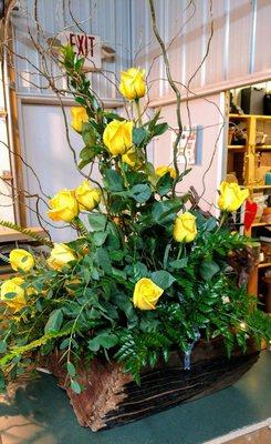 Fresh Yellow roses, in a driftwood vase.