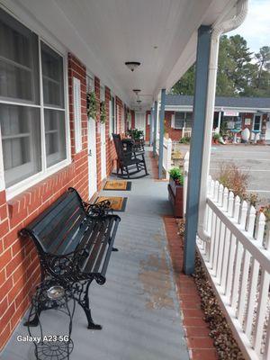 Porch with bench & comfortable black rocking chairs for our guests. Smoking is allowed outside