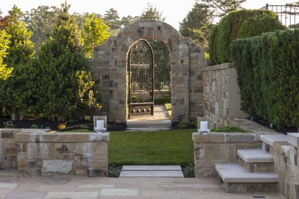 A custom stone and wrought-iron gate to welcome you into the garden.