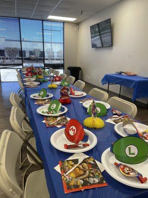 Table set up! The blue tablecloth, white napkins and white plates were provided. We brought the Mario decor