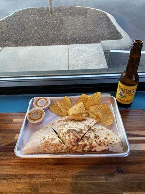 Chicken quesadilla with chips and salsa.