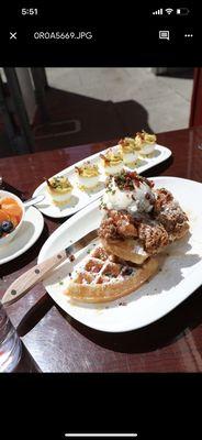 The chicken and waffles brunch dish with deviled eggs on the side.