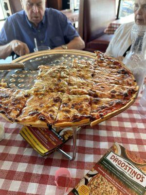 A partially-eaten Famous Thin Crust Cheese Pizza