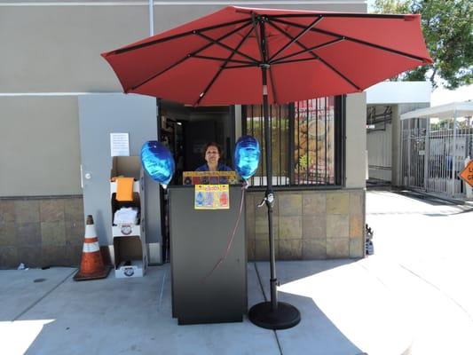 the owner , Mary, selling car fresheners and greeting customers during grand opening